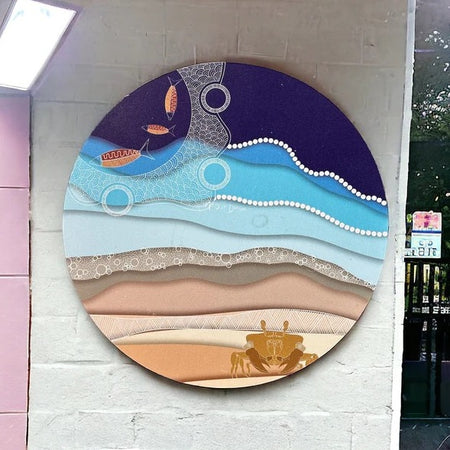 Round metal Indigenous artwork